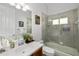 Well-lit bathroom featuring a shower over bath, cherry cabinet, and stylish decorative accents at 12810 Daisy Pl, Bradenton, FL 34212