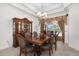 Dining area showcasing a dark wood table, cabinet, chandelier and view of the pool at 12810 Daisy Pl, Bradenton, FL 34212