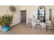 Inviting front porch features a decorative sun ornament, tile flooring and comfortable chairs at 12810 Daisy Pl, Bradenton, FL 34212