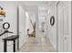Bright hallway with tile flooring, white walls, and decorative accents throughout this beautiful home at 12810 Daisy Pl, Bradenton, FL 34212