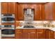 Well-appointed kitchen featuring stainless steel appliances, custom cabinets, and granite countertops at 12810 Daisy Pl, Bradenton, FL 34212