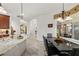 Bright kitchen featuring granite countertops, stainless steel appliances, and an open layout with dining area at 12810 Daisy Pl, Bradenton, FL 34212
