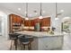 Spacious kitchen featuring wood cabinetry, stainless steel appliances, and a center island with seating at 12810 Daisy Pl, Bradenton, FL 34212