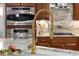 Gourmet kitchen with stainless steel appliances, marble countertops, and a gold faucet at 12810 Daisy Pl, Bradenton, FL 34212
