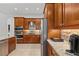Gourmet kitchen featuring wood cabinetry, granite countertops and stainless steel appliances at 12810 Daisy Pl, Bradenton, FL 34212