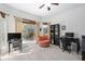 Comfortable living room featuring large windows, tile floors, and an orange swivel chair at 12810 Daisy Pl, Bradenton, FL 34212