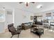 Open living room with a comfortable couch, stylish furniture, and natural light from the windows at 12810 Daisy Pl, Bradenton, FL 34212