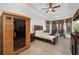 Bright main bedroom features tray ceilings, a sauna, outdoor views, and an entertainment center at 12810 Daisy Pl, Bradenton, FL 34212