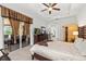 Relaxing main bedroom showcasing furniture, tray ceilings, and slider access to the backyard at 12810 Daisy Pl, Bradenton, FL 34212