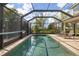 Enclosed pool with clear blue water and tiled deck, perfect for enjoying sunny days with lots of privacy at 12810 Daisy Pl, Bradenton, FL 34212