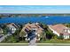 Aerial view of a beautiful house with a lake view and lush landscaping at 14733 Como Cir, Lakewood Ranch, FL 34202