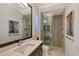 Bathroom featuring a modern vanity, large mirror, and glass-enclosed shower with decorative tiles at 14733 Como Cir, Lakewood Ranch, FL 34202