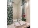 Stylish bathroom featuring a unique mosaic mirror, modern sink, and elegant lighting fixtures at 14733 Como Cir, Lakewood Ranch, FL 34202