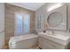 Well-lit bathroom with a soaking tub, modern vanity, and stylish finishes for a spa-like experience at 14733 Como Cir, Lakewood Ranch, FL 34202