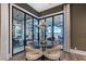 This dining area has a modern chandelier, neutral chairs, and expansive views of the waterway at 14733 Como Cir, Lakewood Ranch, FL 34202