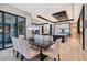Bright dining area featuring a modern chandelier, sleek dining table, and adjacent open-concept kitchen and living spaces at 14733 Como Cir, Lakewood Ranch, FL 34202