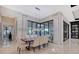 Elegant dining room with modern chandelier, large windows, and view of the water at 14733 Como Cir, Lakewood Ranch, FL 34202