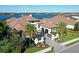 Stunning waterfront home with a tile roof, lush landscaping, and a brick driveway at 14733 Como Cir, Lakewood Ranch, FL 34202