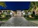 Beautiful exterior view of a home with manicured landscaping at night at 14733 Como Cir, Lakewood Ranch, FL 34202