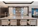 Luxurious kitchen with marble countertops, a stainless steel range hood, and seating at the island at 14733 Como Cir, Lakewood Ranch, FL 34202