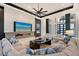 Elegant living room with a modern fireplace, large TV, comfortable sectional, and floor-to-ceiling windows at 14733 Como Cir, Lakewood Ranch, FL 34202