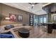 Spacious living room featuring a sectional sofa, wet bar area, and sliding glass doors leading to outdoor space at 14733 Como Cir, Lakewood Ranch, FL 34202