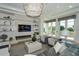 Elegant living room features a modern fireplace, built-in shelves, and access to a balcony at 14733 Como Cir, Lakewood Ranch, FL 34202