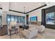Cozy living room with fireplace, stylish seating, and beautiful waterfront views at 14733 Como Cir, Lakewood Ranch, FL 34202