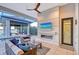 Enjoy this covered outdoor living space with a linear fireplace, television, and waterfront view at 14733 Como Cir, Lakewood Ranch, FL 34202