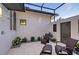 Inviting outdoor area featuring an outdoor shower, stylish chairs, and lush landscaping for relaxation at 14733 Como Cir, Lakewood Ranch, FL 34202