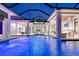 Expansive pool with fountain and waterfall features, seamlessly blending indoor and outdoor living at 14733 Como Cir, Lakewood Ranch, FL 34202