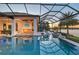Spacious outdoor pool area with waterfront views, outdoor grill, and seamless indoor/outdoor living at 14733 Como Cir, Lakewood Ranch, FL 34202