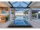 Beautiful screened-in pool area featuring a cabana and a peaceful lake view at 14733 Como Cir, Lakewood Ranch, FL 34202
