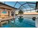 Beautiful pool area with outdoor kitchen, waterfront views, and comfortable lounge seating at 14733 Como Cir, Lakewood Ranch, FL 34202