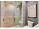 Modern shower with glass door, neutral tile and built-in seat provides style and convenience at 14733 Como Cir, Lakewood Ranch, FL 34202