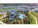 Beautiful aerial view featuring a community pool, clubhouse, and surrounding ponds at 1901 Everson St, Bradenton, FL 34208