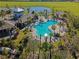 Aerial view of a community pool, clubhouse, and lush landscaping at 1901 Everson St, Bradenton, FL 34208
