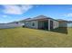 Exterior back view with a screened lanai and a well-manicured lawn at 1901 Everson St, Bradenton, FL 34208