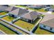 A private backyard features a white vinyl fence, green lawn, and partial view of surrounding neighborhood at 1901 Everson St, Bradenton, FL 34208