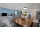 Open dining room with wood table adjacent to living room and kitchen area at 1901 Everson St, Bradenton, FL 34208