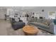 Comfortable living room with open floor plan leading to kitchen, featuring stylish gray furnishings at 1901 Everson St, Bradenton, FL 34208