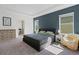 Beautiful main bedroom with tray ceiling, blue accent wall, and ensuite bathroom at 1901 Everson St, Bradenton, FL 34208