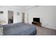 Spacious main bedroom with a TV stand, carpet flooring, and access to a walk-in closet and bathroom at 1901 Everson St, Bradenton, FL 34208