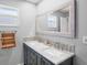 Bathroom featuring double sinks, framed mirrors and mosaic tile backsplash at 264 S Harbor Dr, Holmes Beach, FL 34217