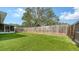 Green artificial turf in backyard with wood fence and access to enclosed patio at 3085 Goldenrod St, Sarasota, FL 34239