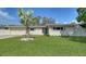 Charming single-story home with a lush green lawn and a decorative palm tree at 3085 Goldenrod St, Sarasota, FL 34239