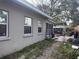 View of the house from the side yard with windows, fence, and covered lounge seating at 3305 13Th W Ave, Bradenton, FL 34205