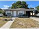Charming single-story home featuring a covered carport and a walkway leading to the front door at 3305 13Th W Ave, Bradenton, FL 34205