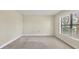 Bedroom featuring neutral paint, soft carpet, a large window, and is illuminated by natural light at 3629 Longmeadow # 38, Sarasota, FL 34235