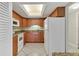 Well-lit kitchen featuring wood cabinetry, granite countertops, and modern appliances at 3629 Longmeadow # 38, Sarasota, FL 34235